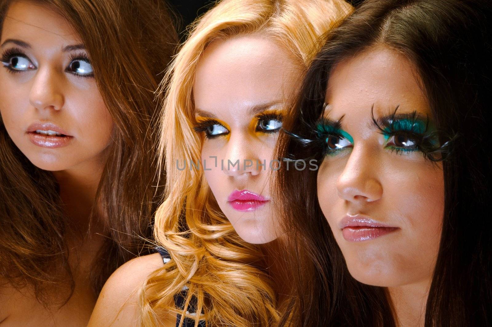 A group of young models against dark background a the studio