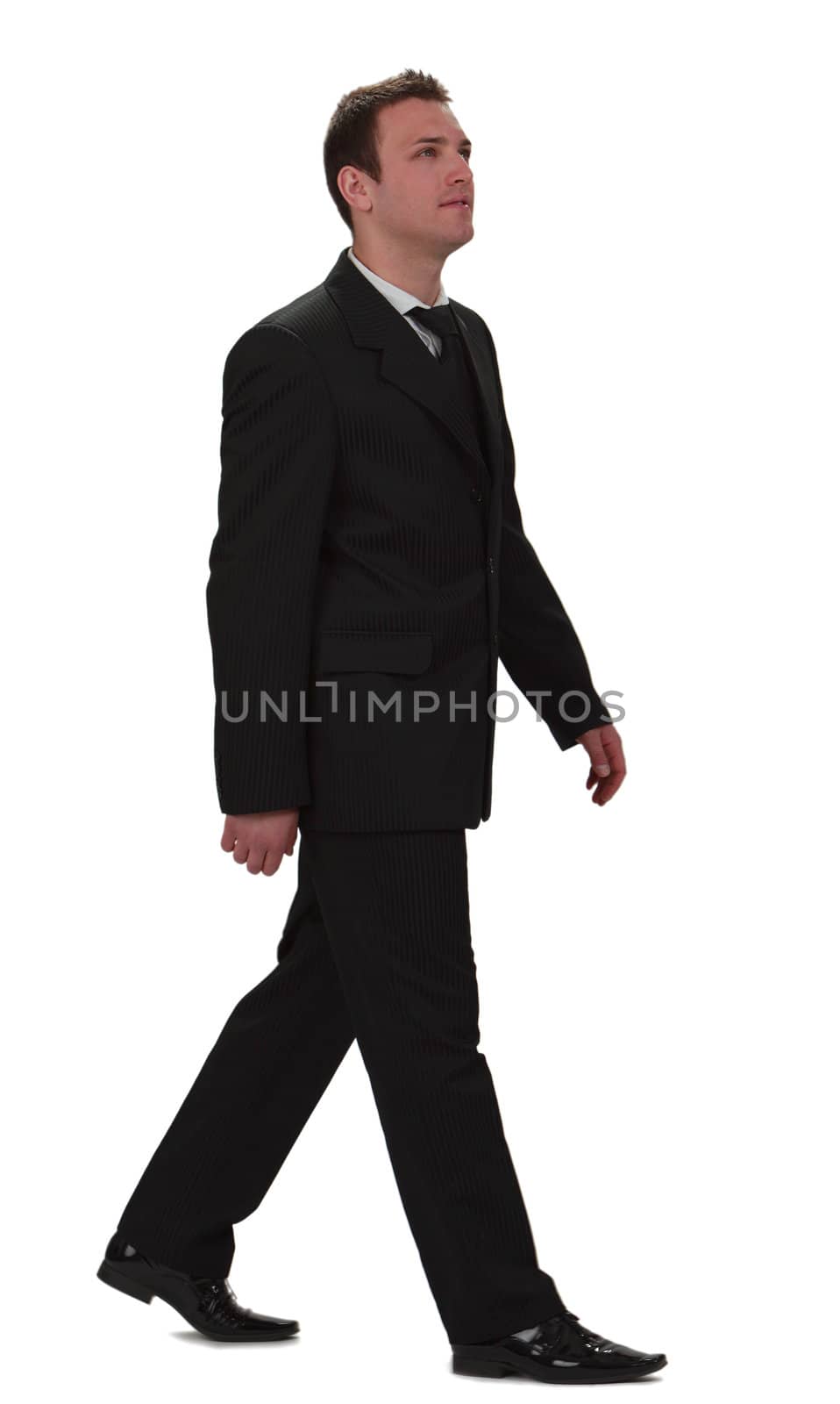 Image of a young businessman walking, isolated against a white background.