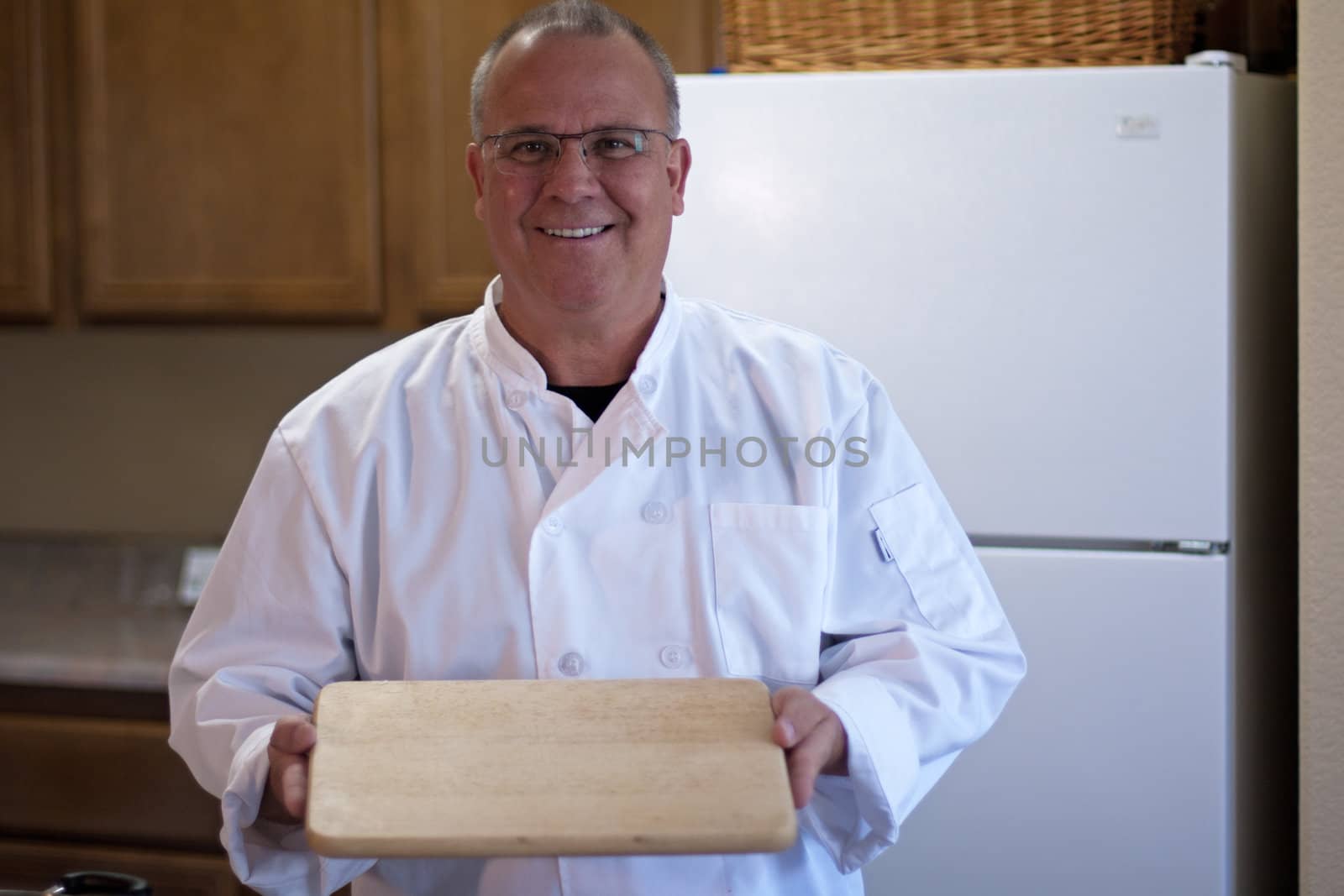 Chef with empty cutting board and space for food design