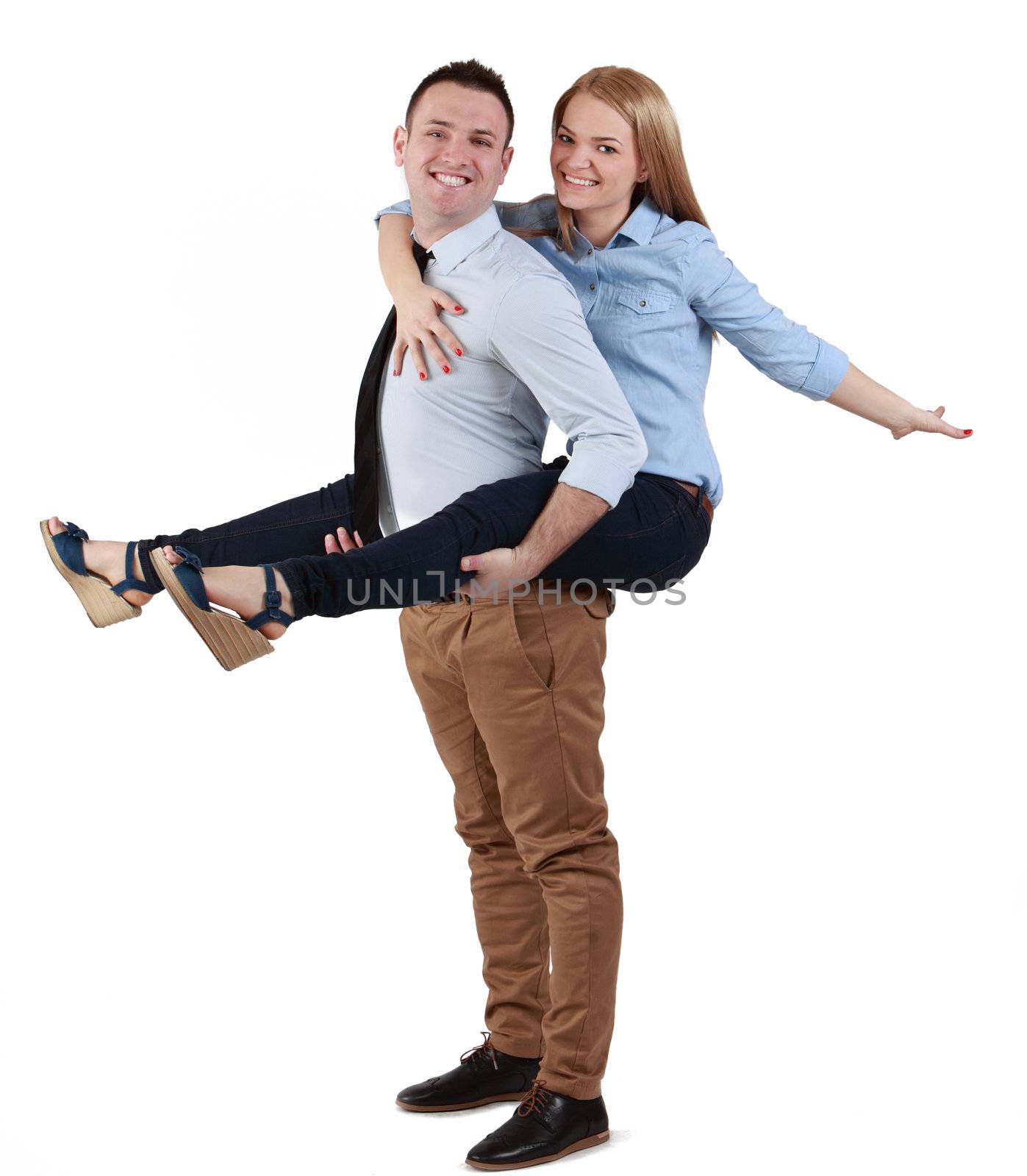 Image of a young couple having fun together against a white background.