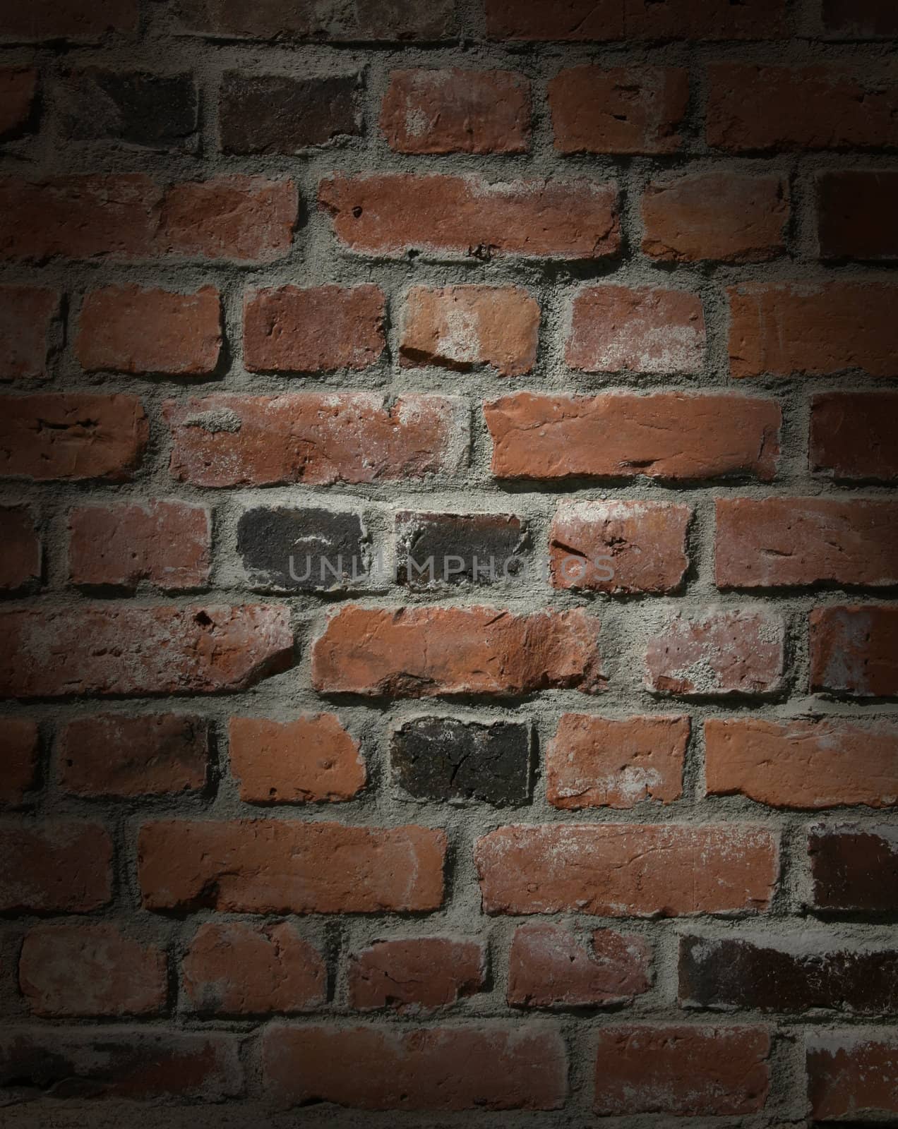 Dark brick  wall with dramatic spot lighting