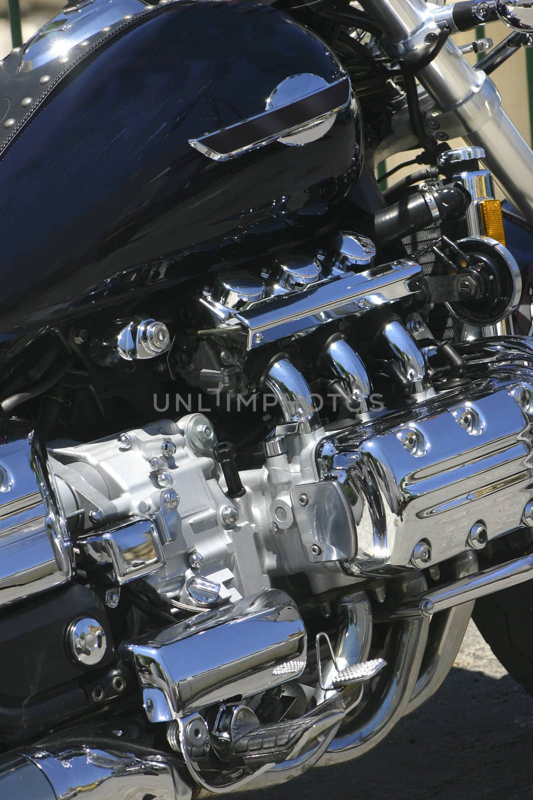 Polished chromed motorcycle engine shining in bright noon light