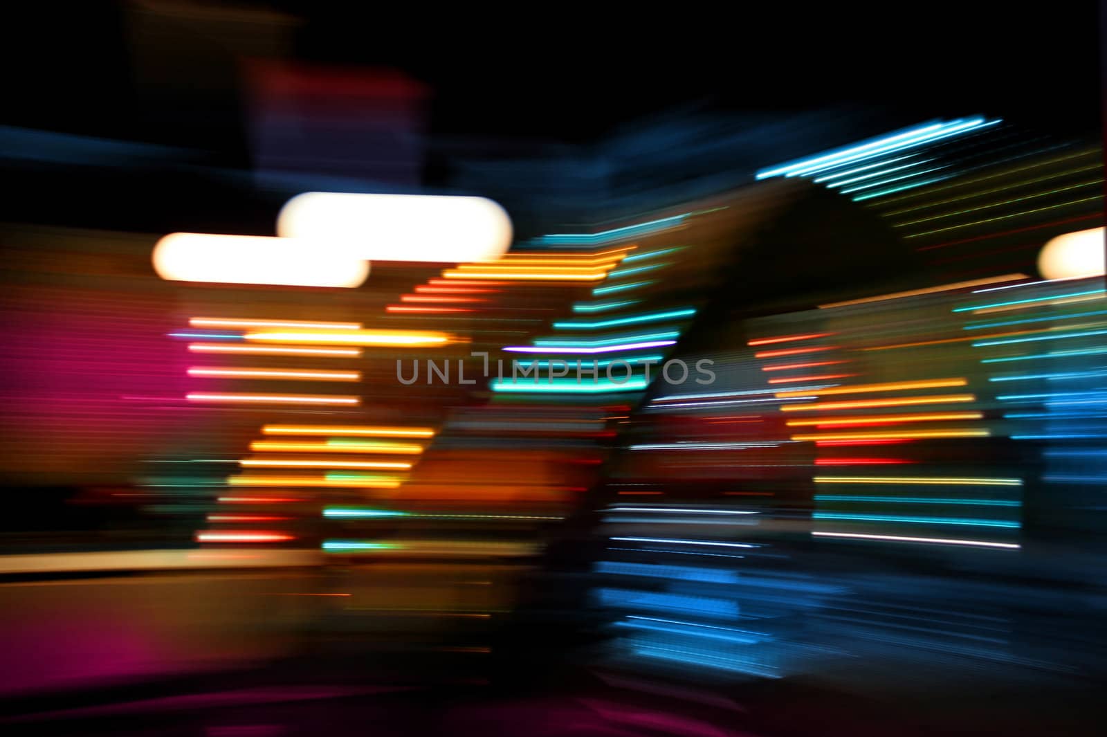 Colorful lights of urban surrounding blurred by motion