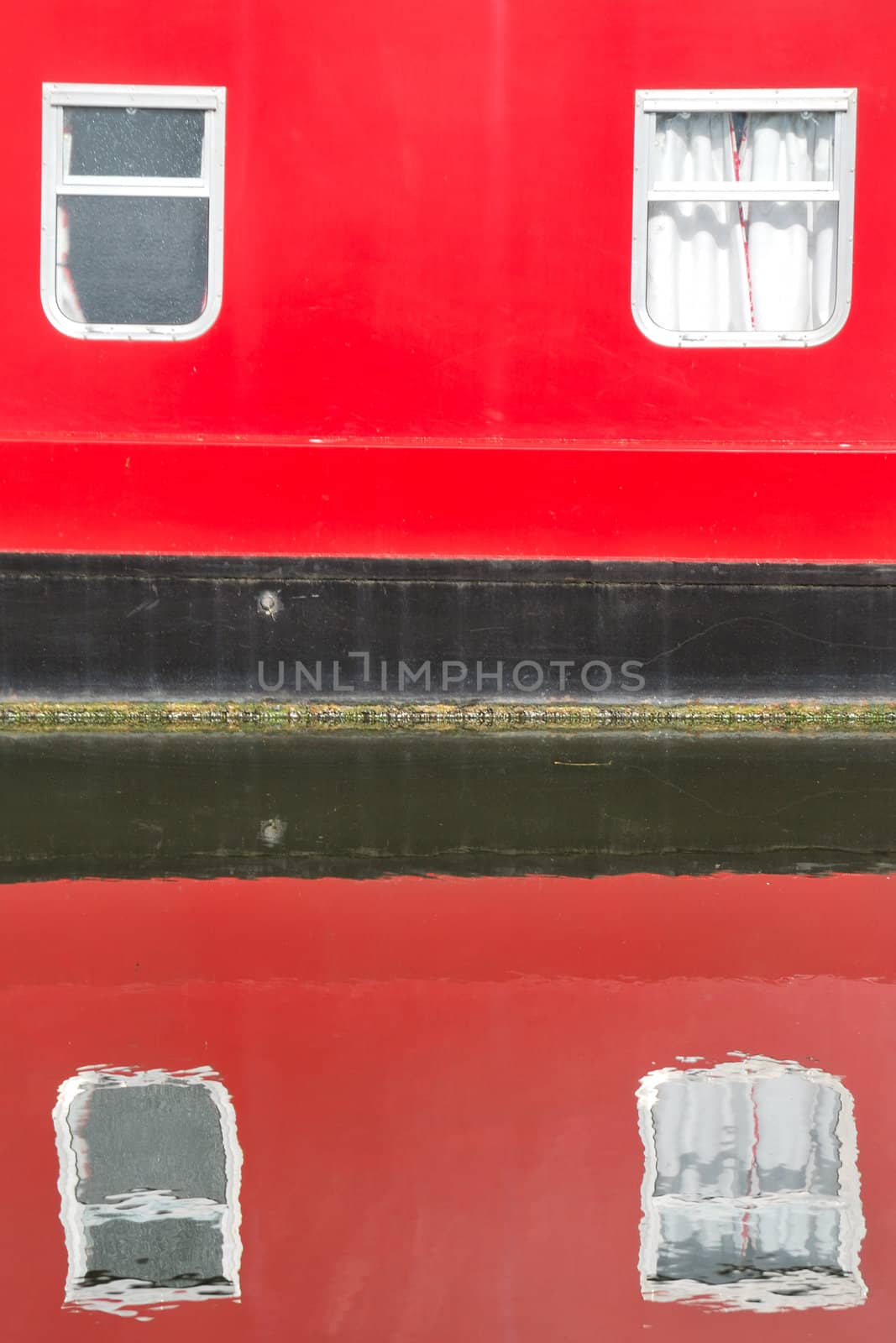 Part of house boat reflecting in the water