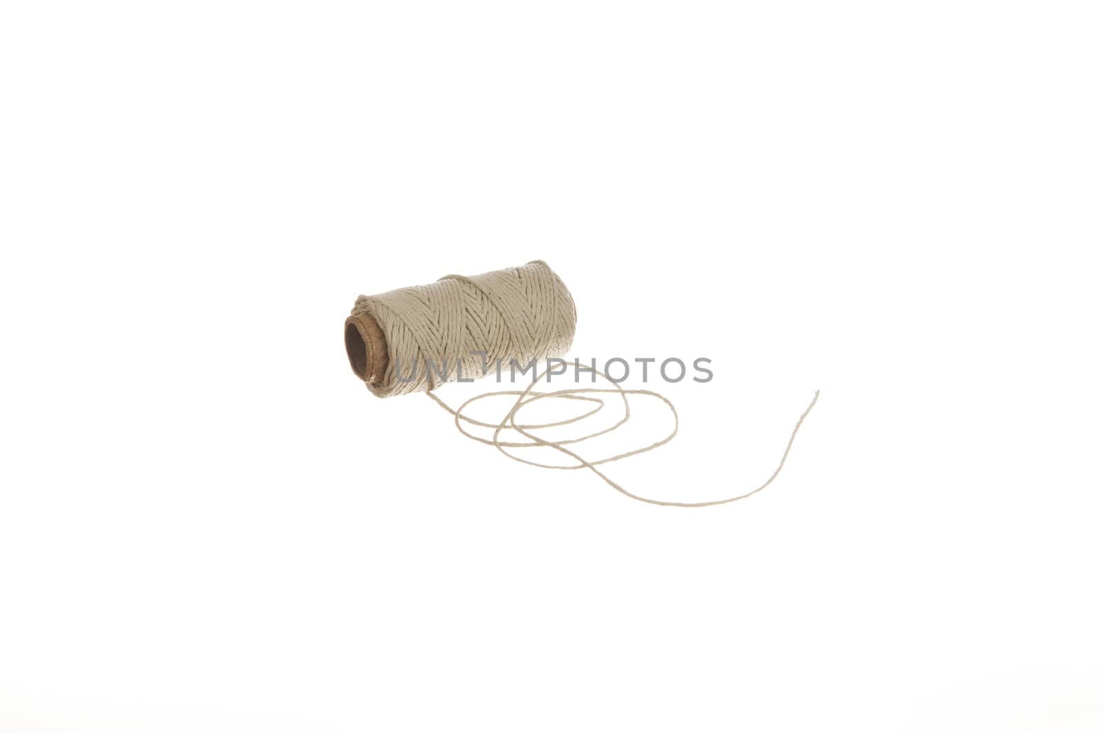 Natural hemp cord isolated on white background by Eydfinnur