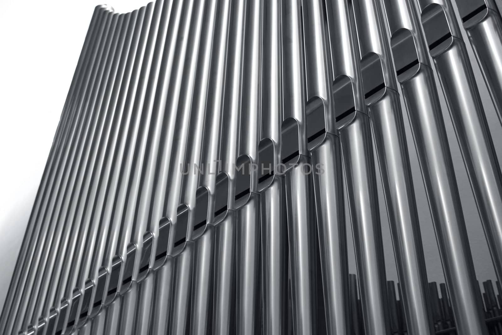 Modern steel organ pipes in a row descending