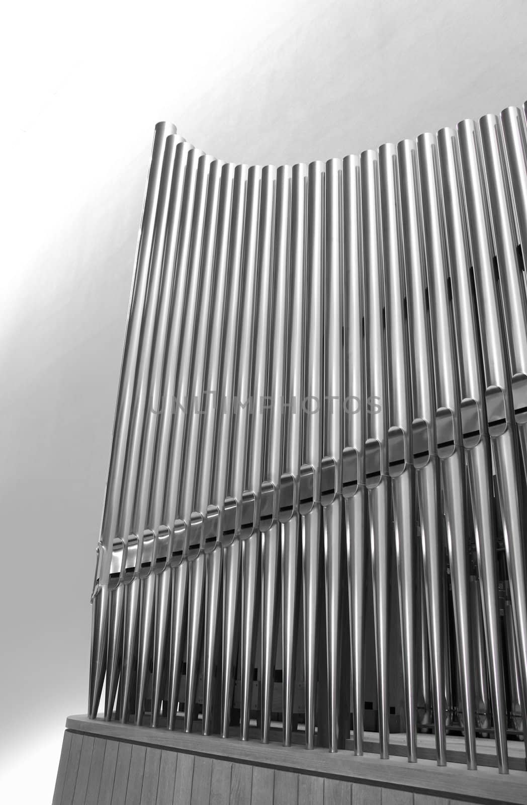 Set of modern steel organ pipes on light background