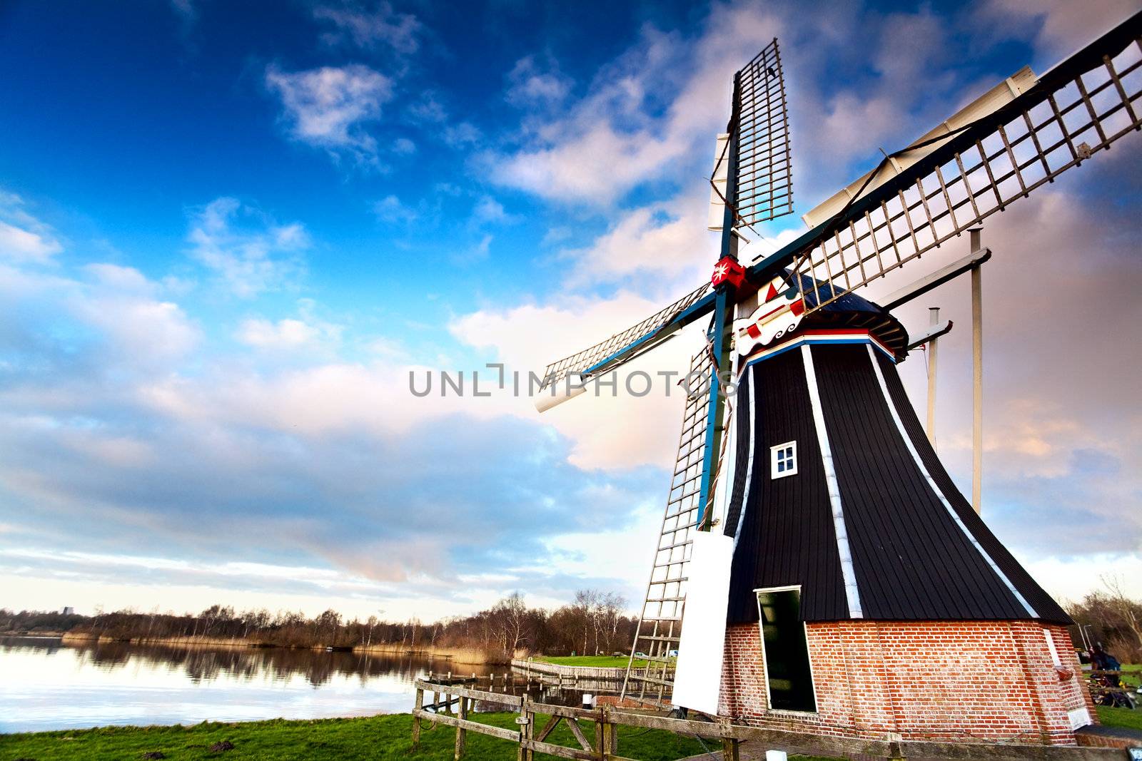 view on typical Dutch windmill over blue sky via wide angle