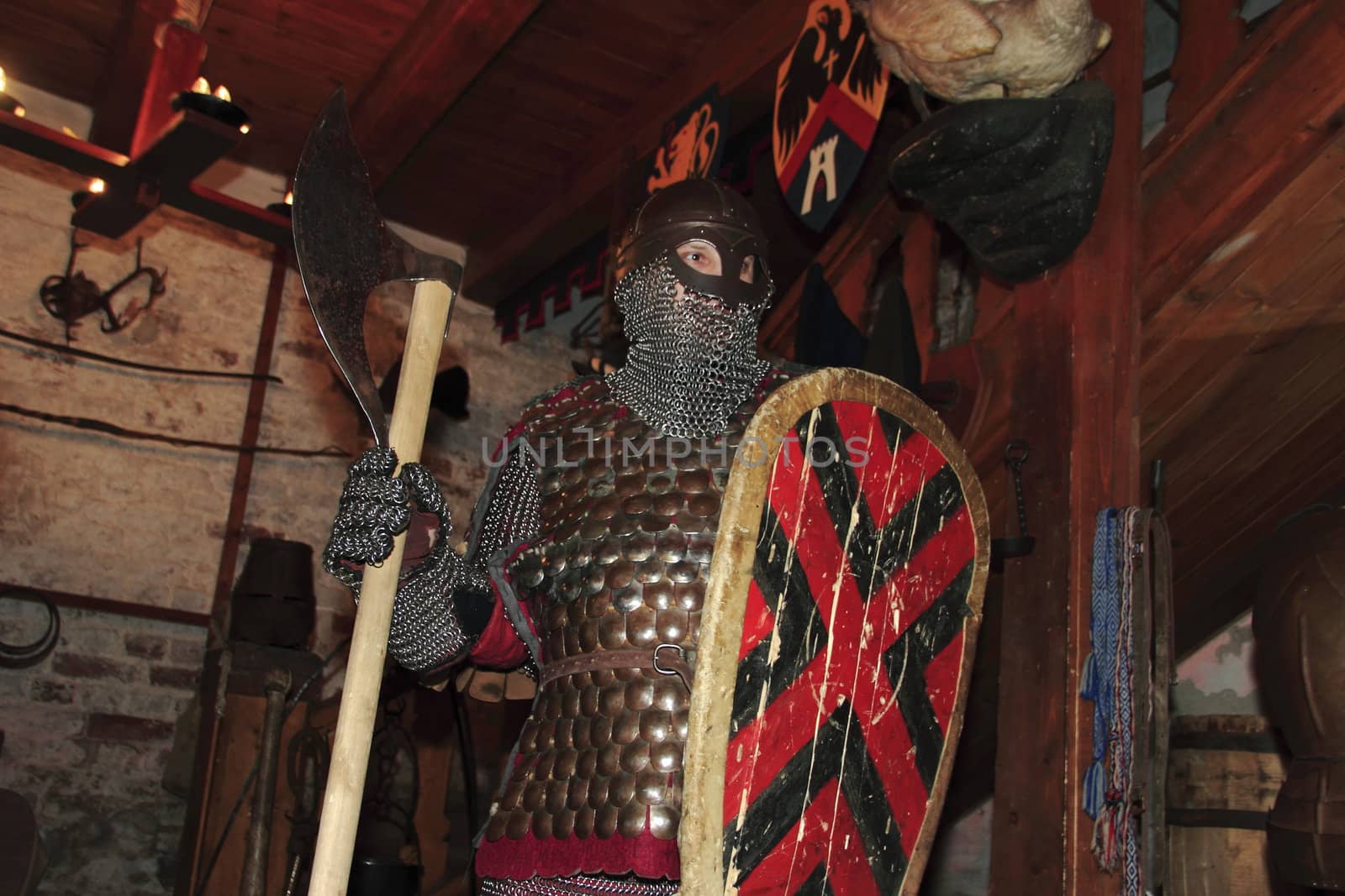 warlike knight in armor against the fortress wall