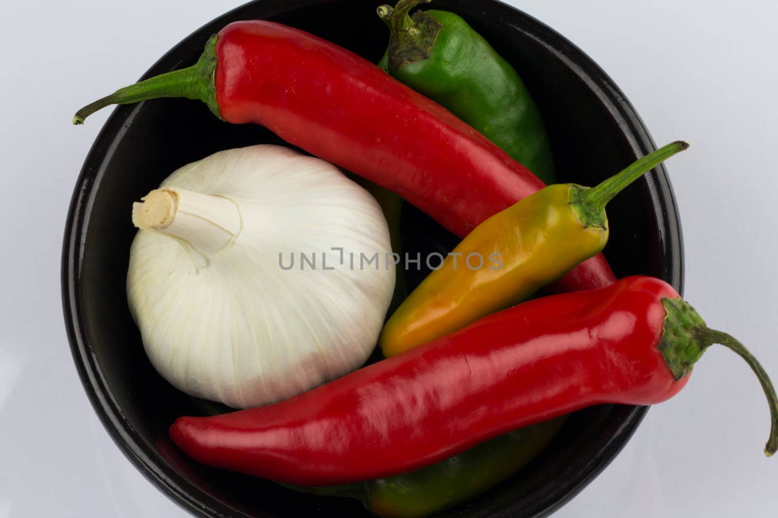 A black bowl of garlic and chilli
