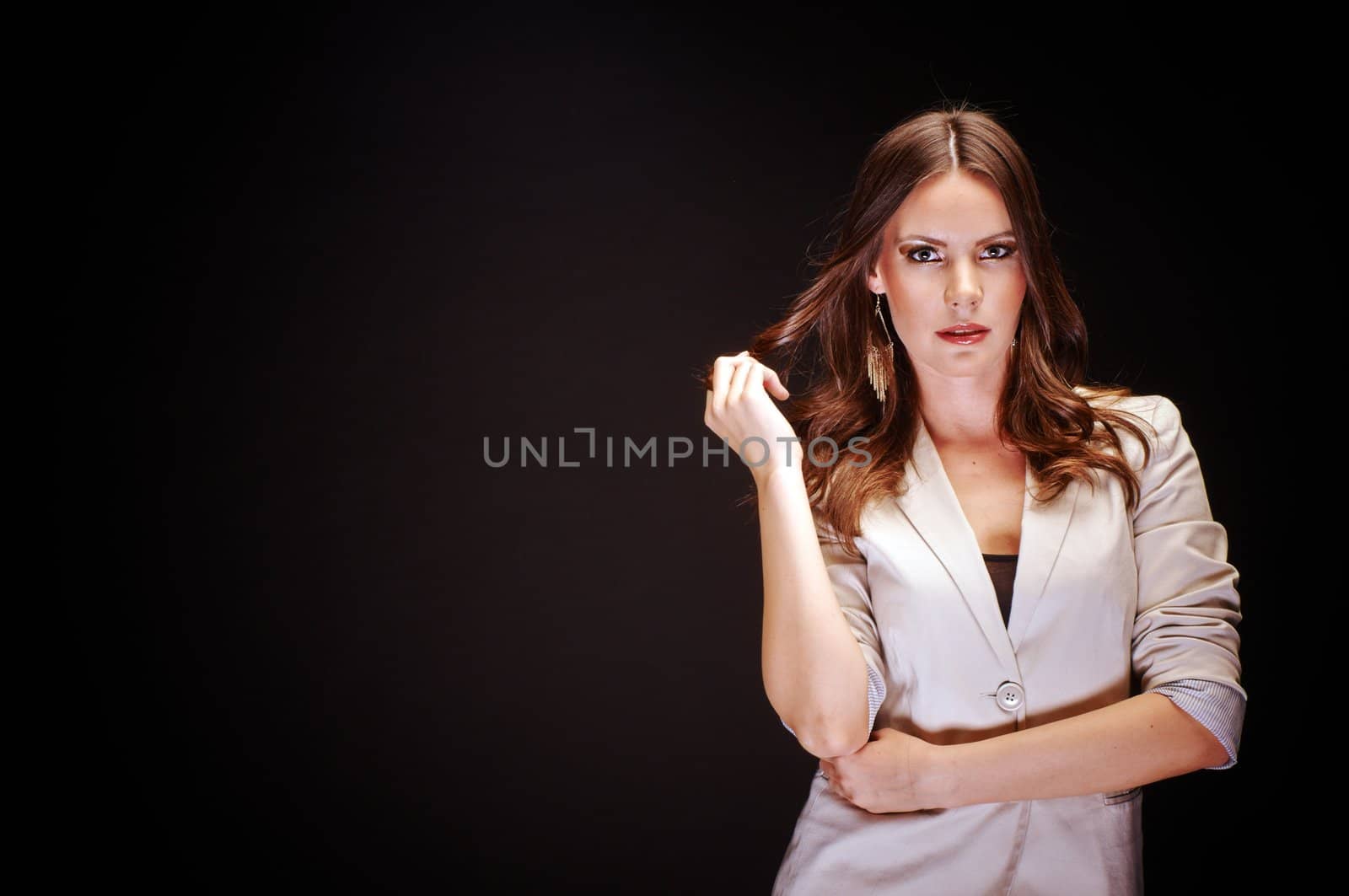 Beautiful young woman against dark background