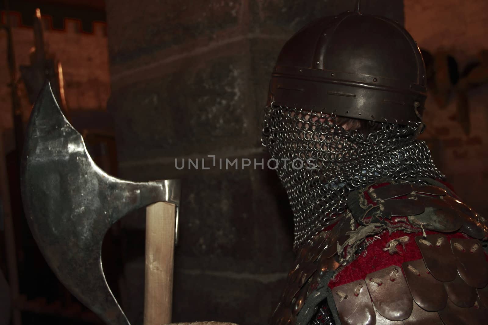 warlike knight in armor against the fortress wall