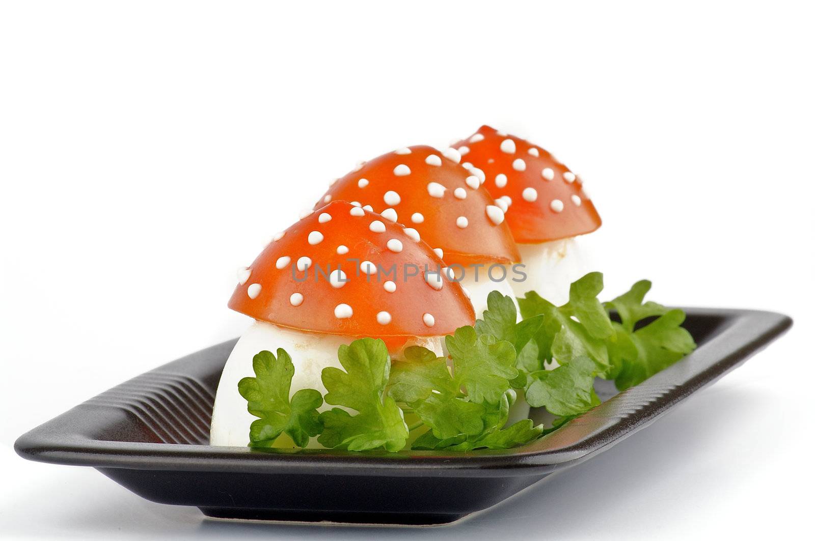 Fly mushroom formed from boiled egg, cover with the tomato mayonnaise. Funny food for children or party.
