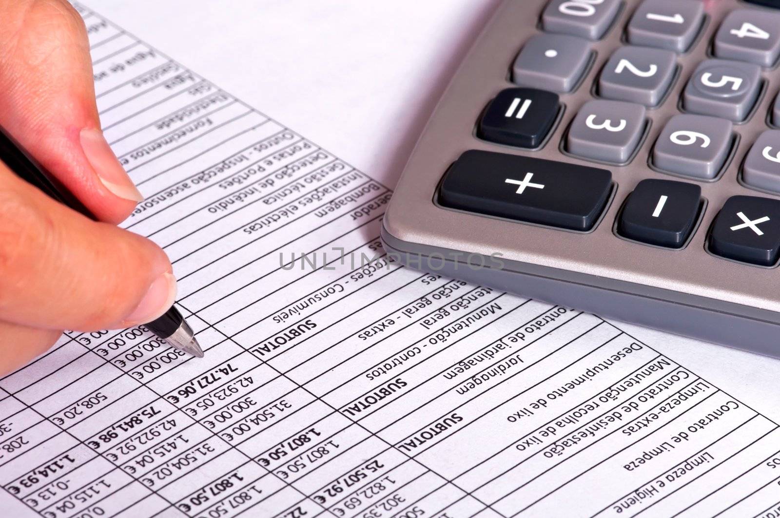 Businessperson doing accounts next to a calculator