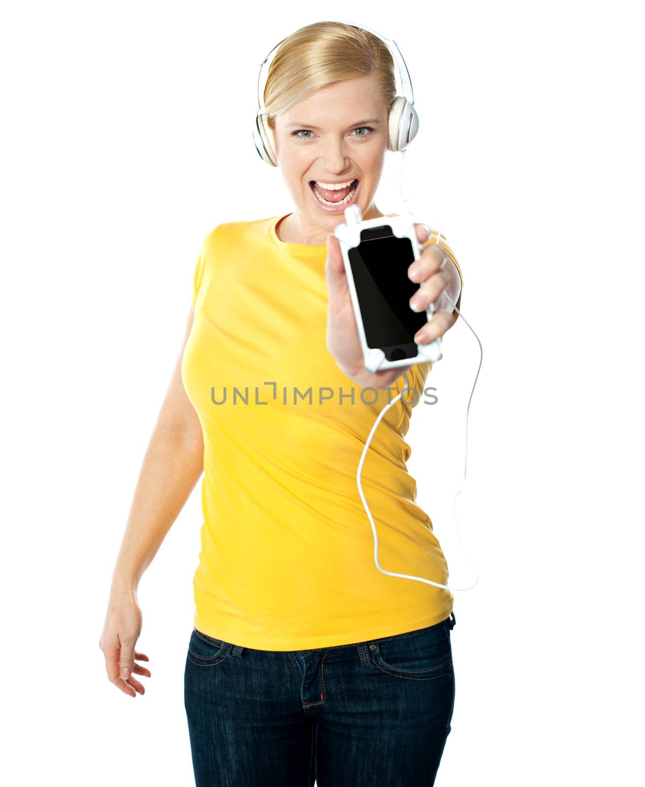 Happy glamorous lady enjoying music by stockyimages