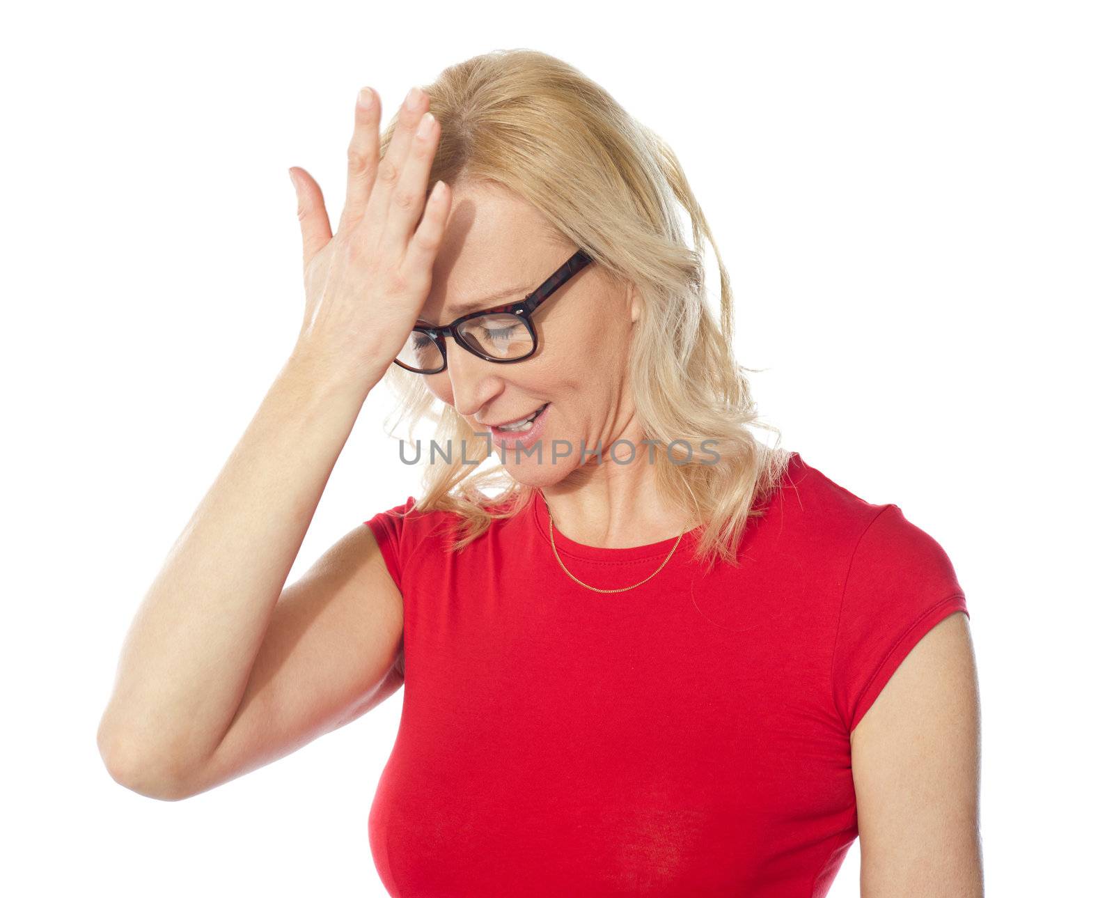 Middle aged frustrated woman holding her head over white background