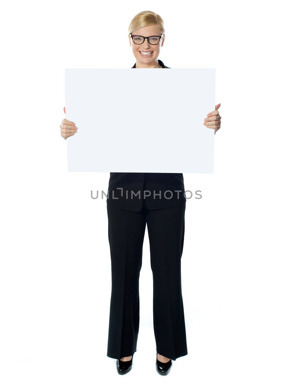 Smiling young lady holding blank banner ad isolated over white background
