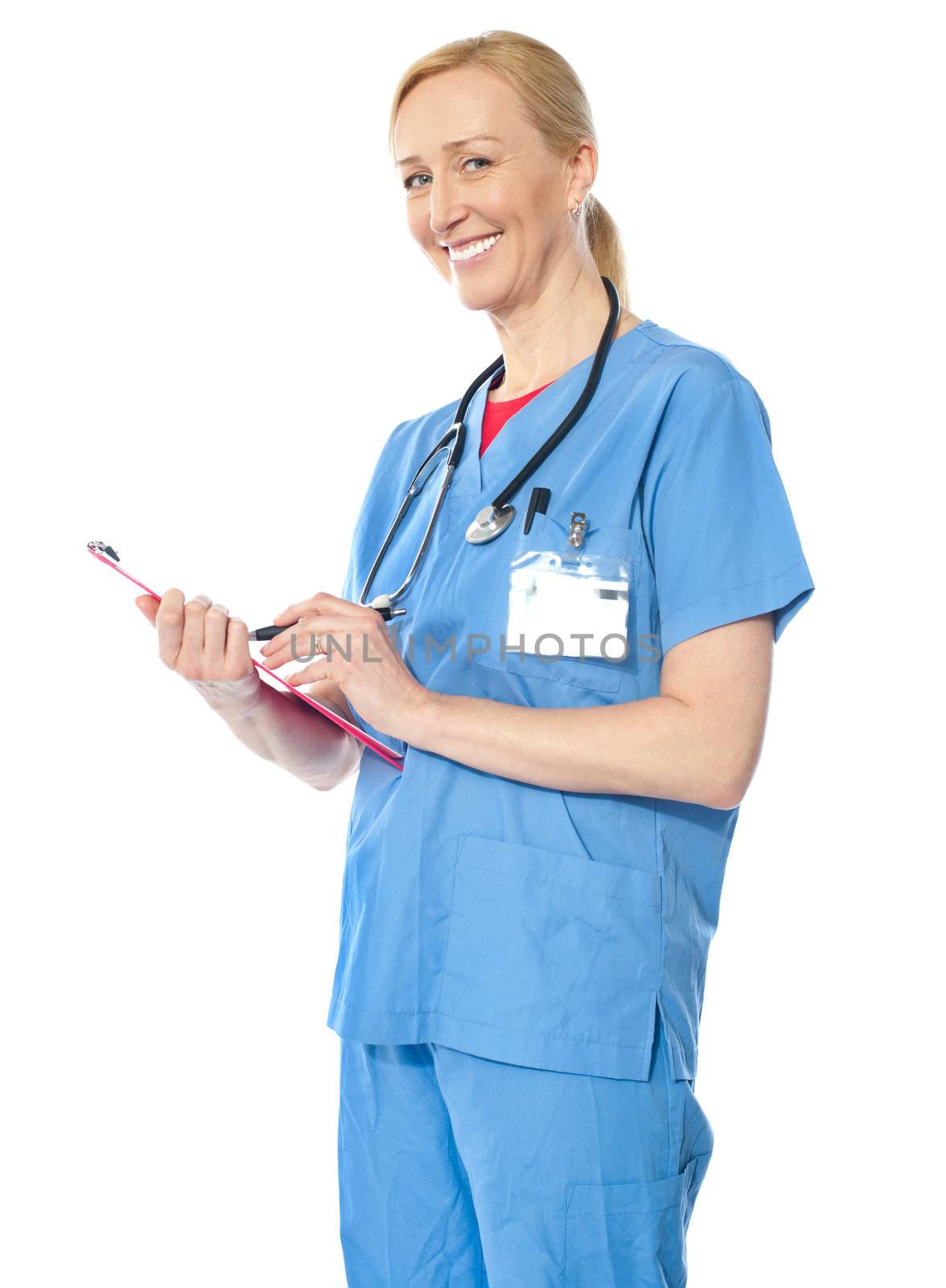 Confident senior doctor writing report and smiling at camera