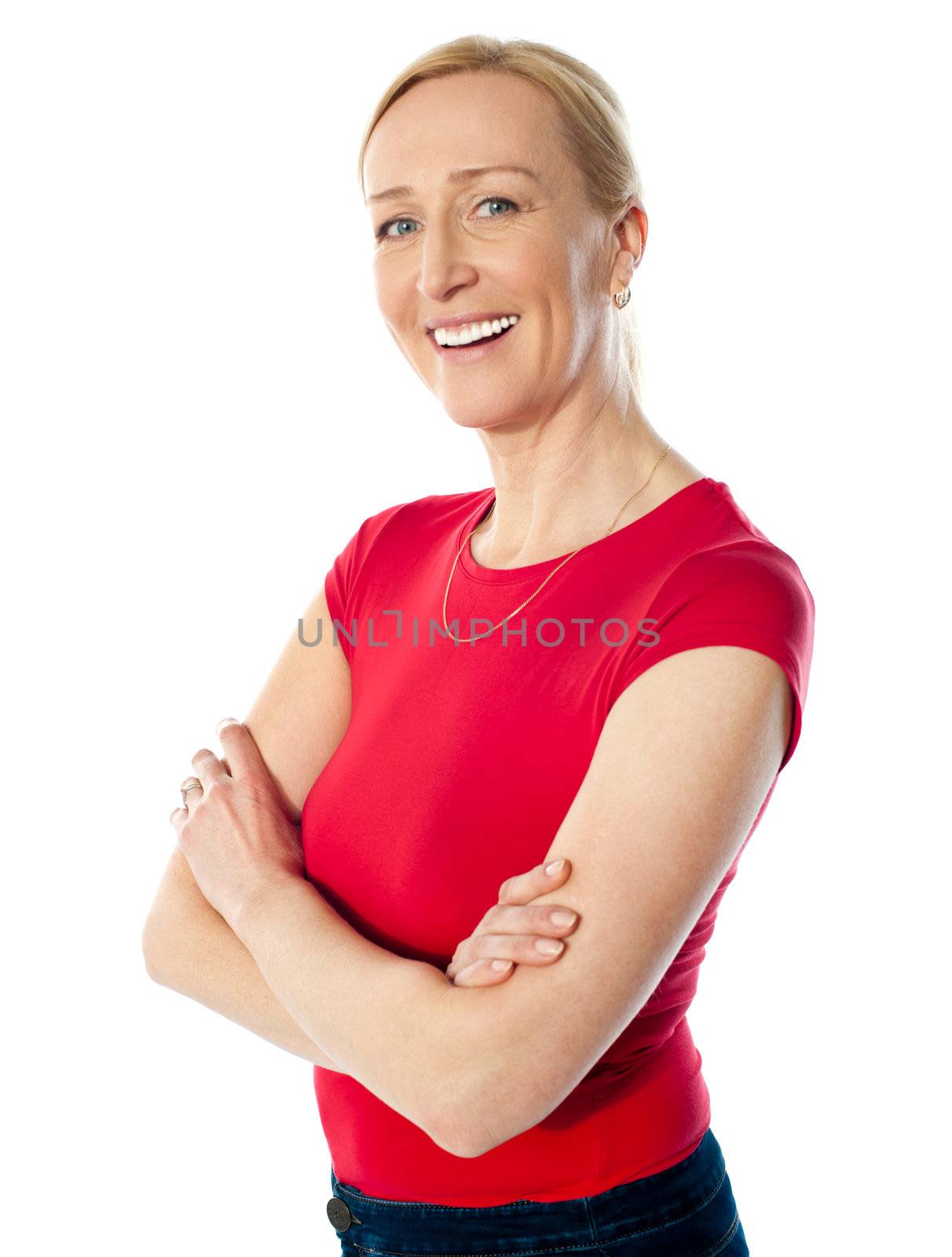 Smiling middle aged lady, poisng with folded arms isolated over white background