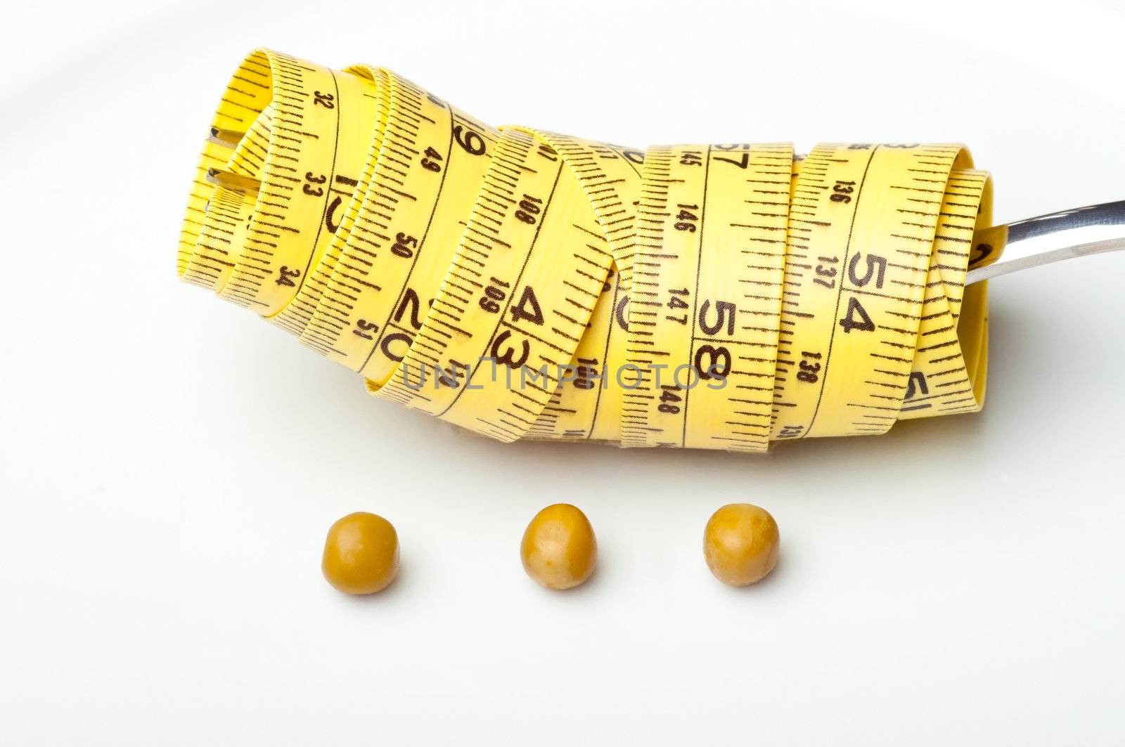 Plate with three peas and a measuring tape around a fork.