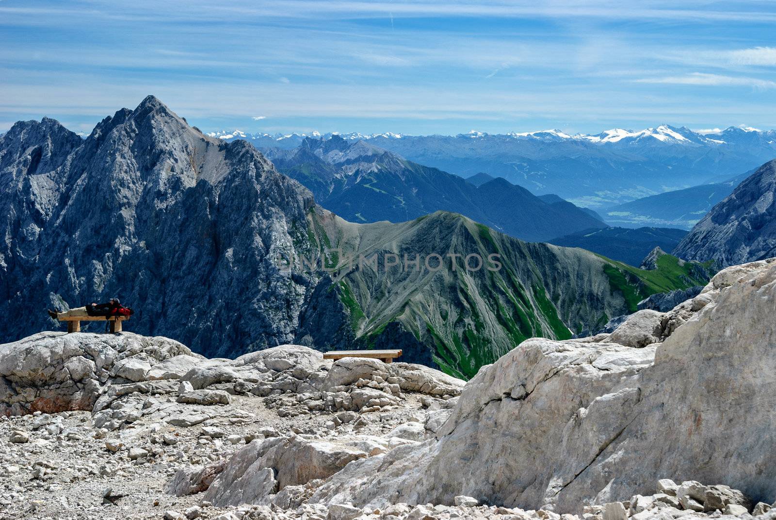 A man is sleeping on a bench near the top of Zugspitze, the highest mountain in Germany.