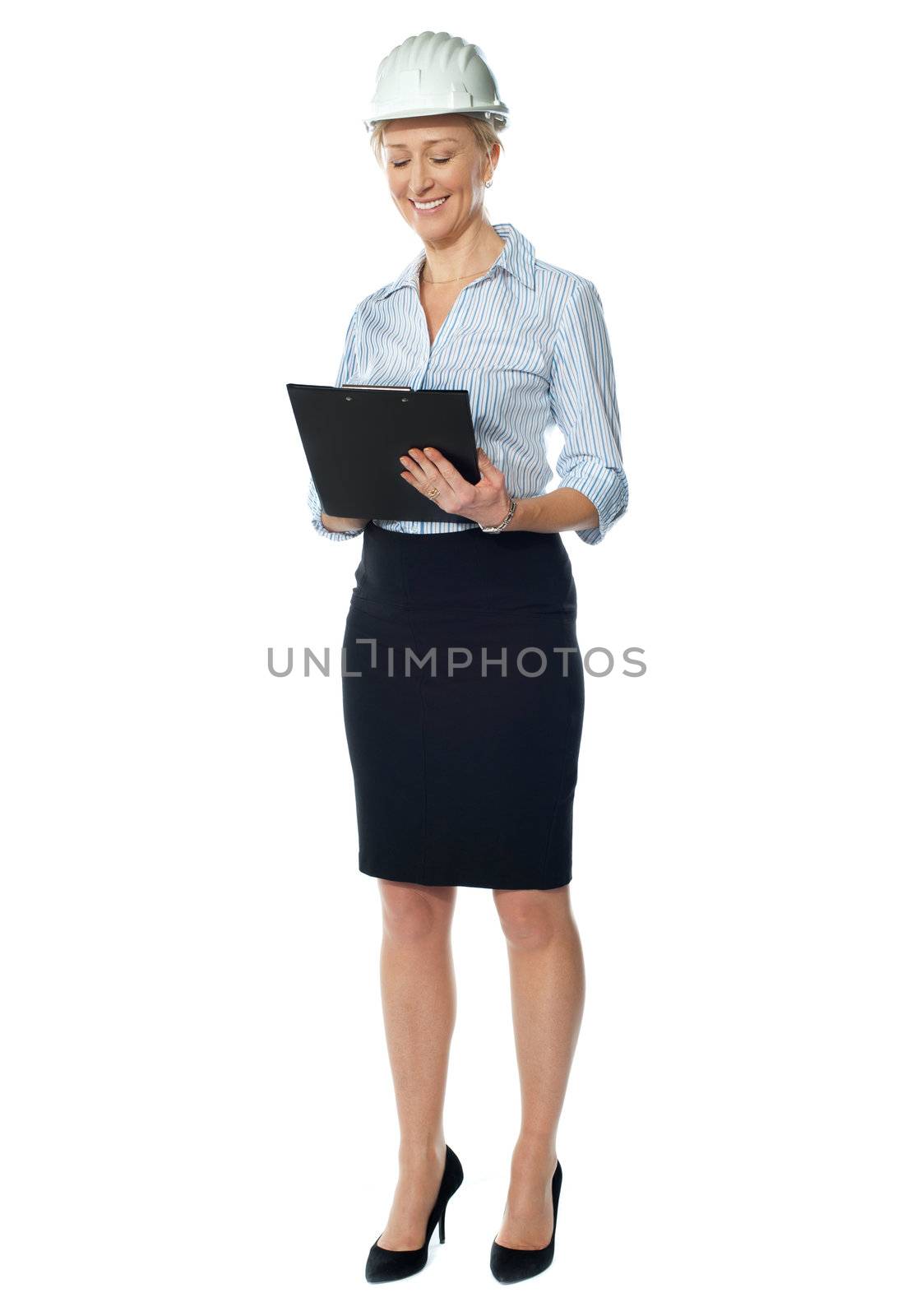 Elderly female architect posing in style as she look at her file