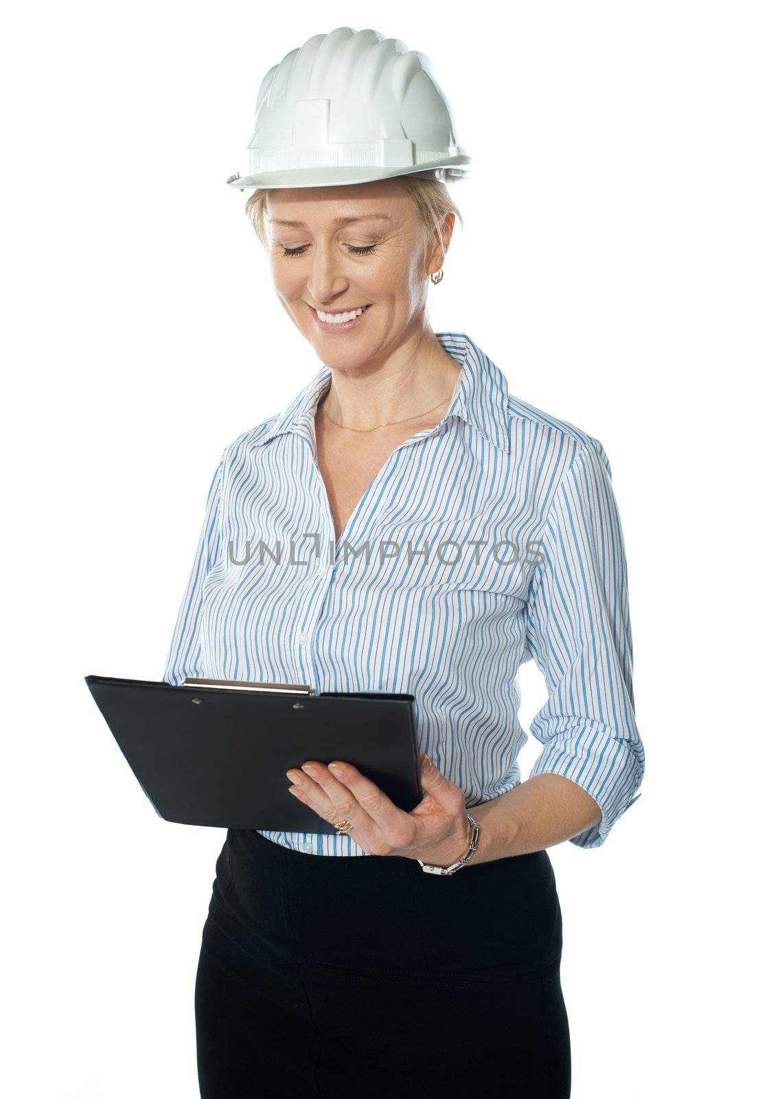 Experienced builder wearing helmet, reviewing papers isolated on white background