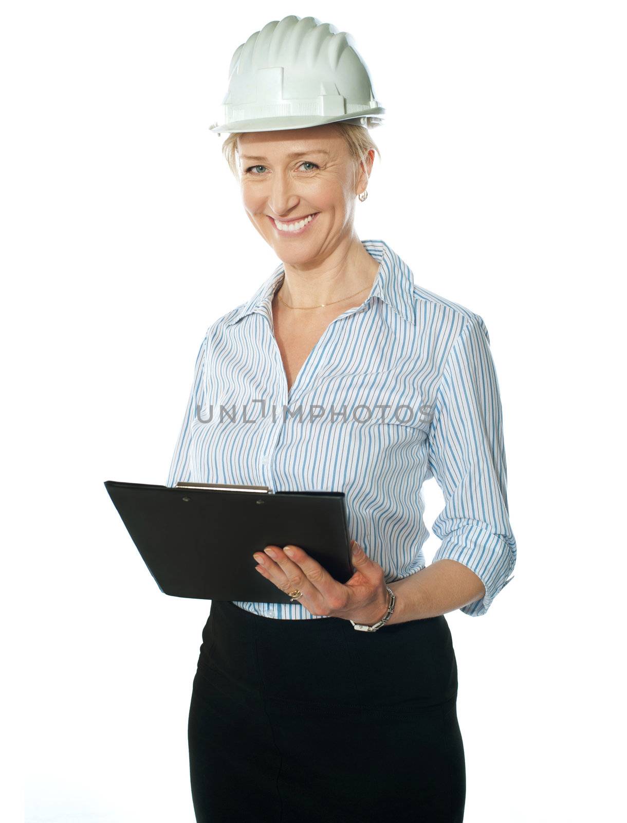Smiling female architect holding documents by stockyimages