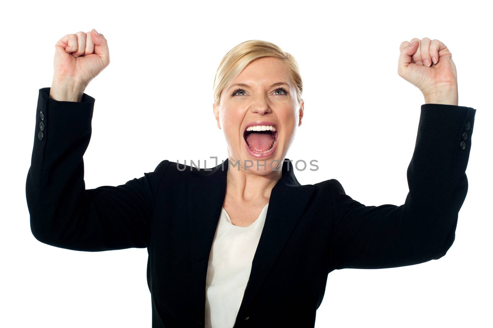 Corporate lady shouting with arms up by stockyimages