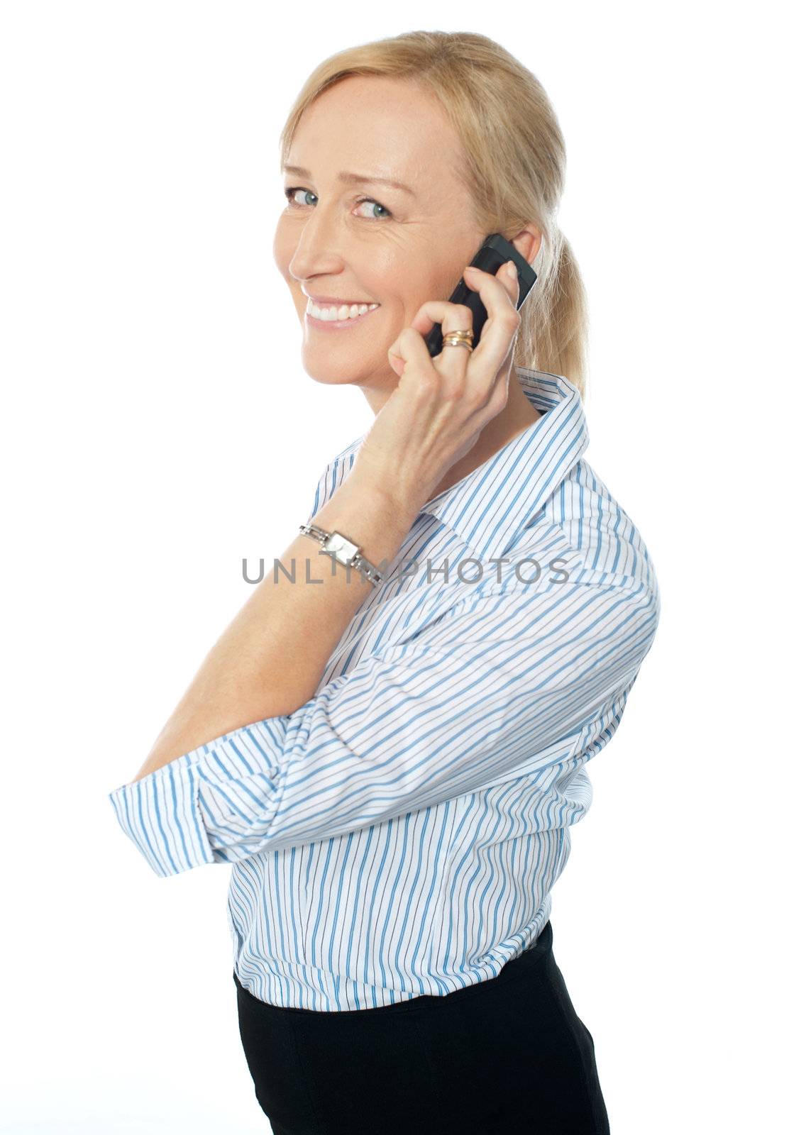 Businesswoman talking on phone and smiling at camera
