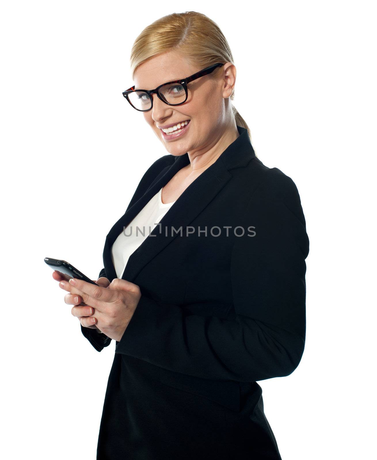 Female business executive texting on phone in front of camera