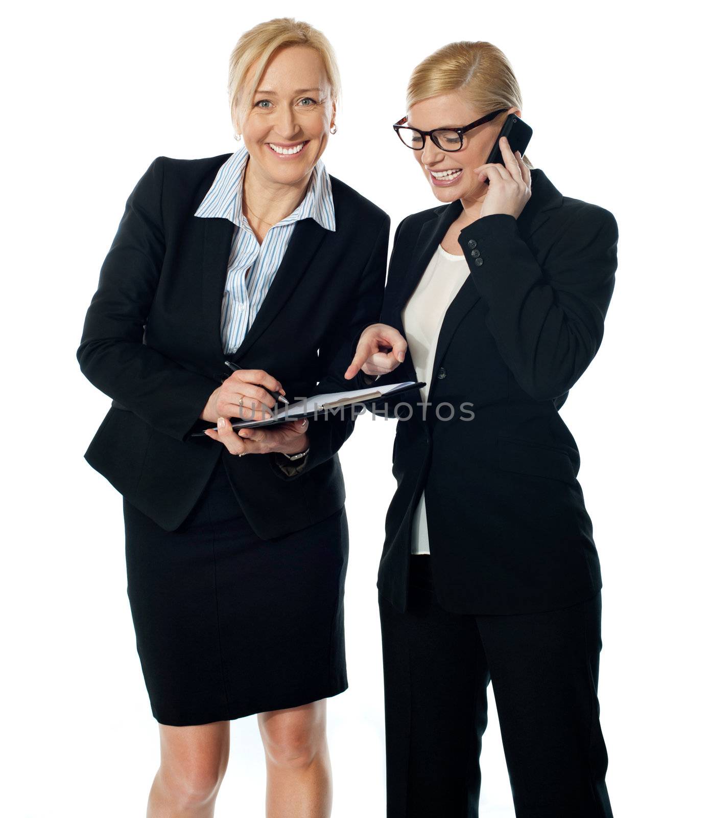 Businesswomen on call rectifying the document. Two corporate women