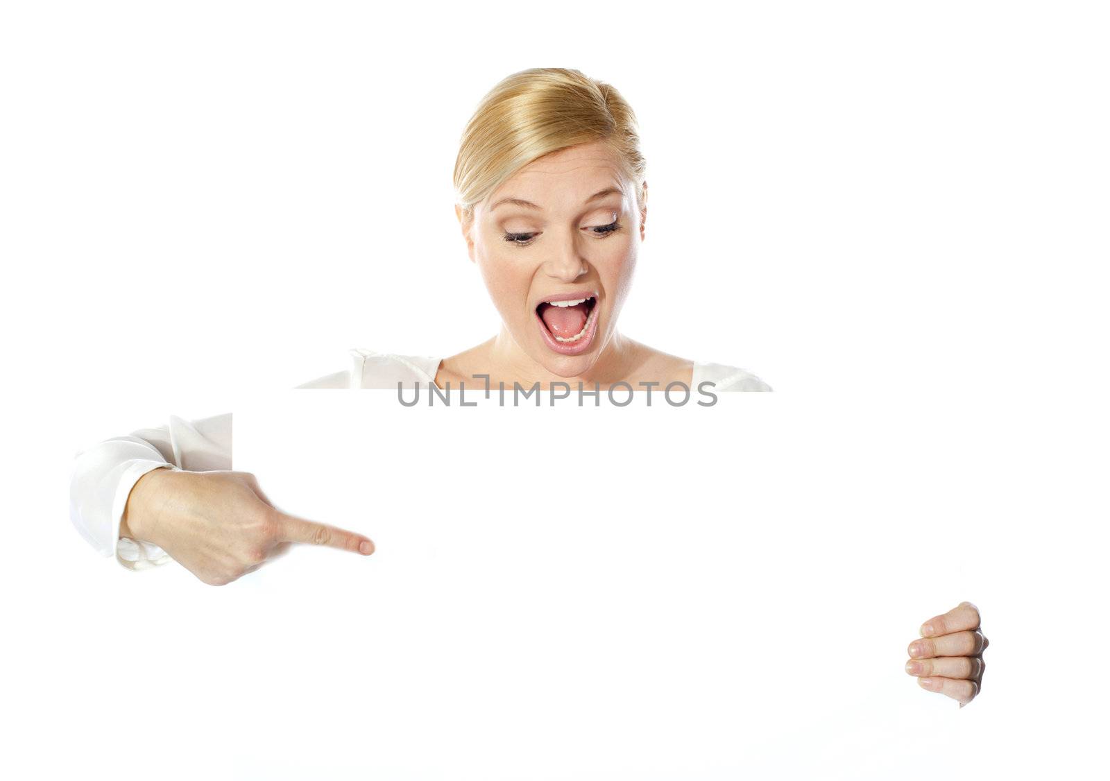 Gorgeous woman pointing at blank clipboard by stockyimages