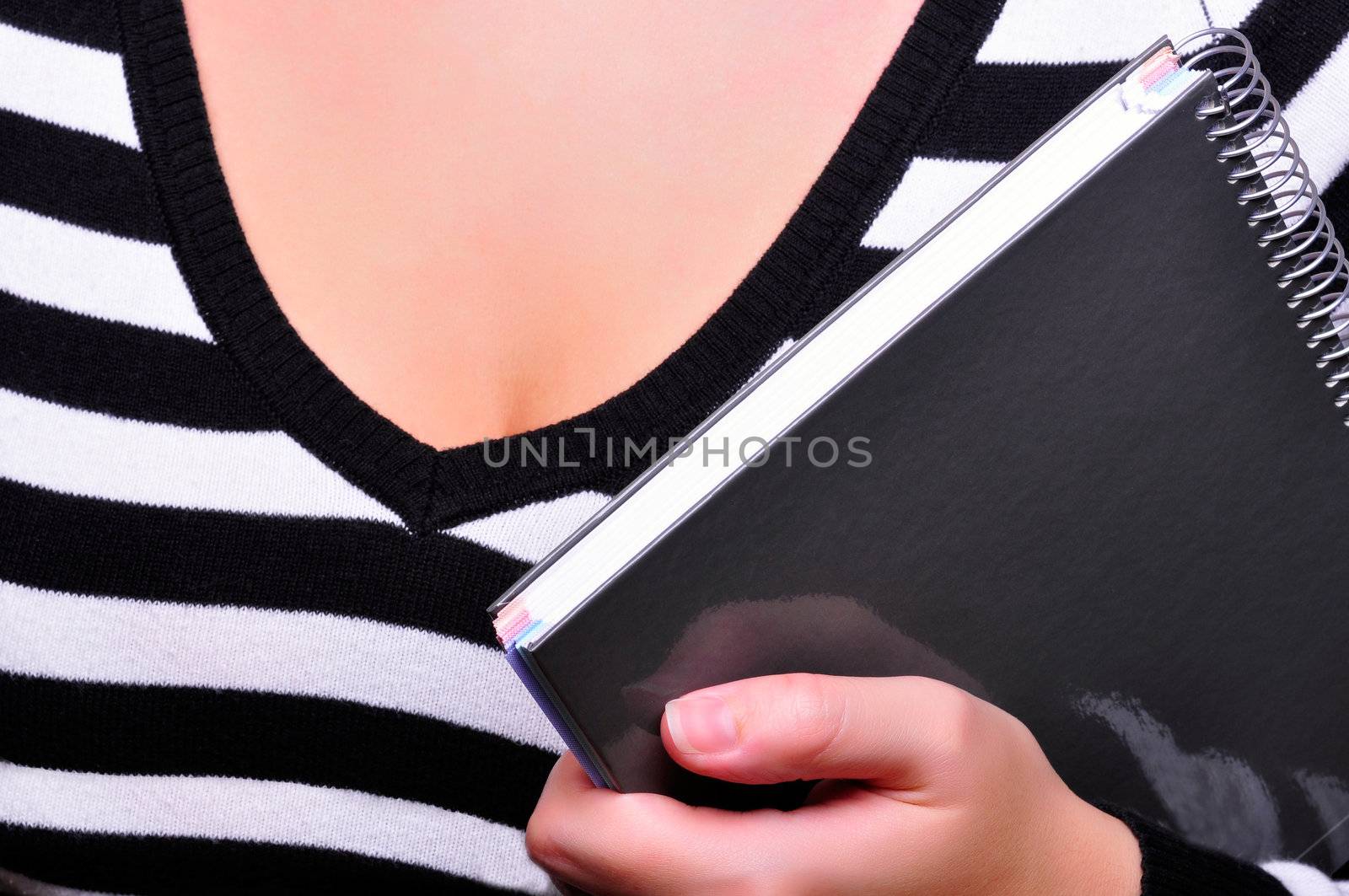 Closeup of a schoolgirl holding a notepad