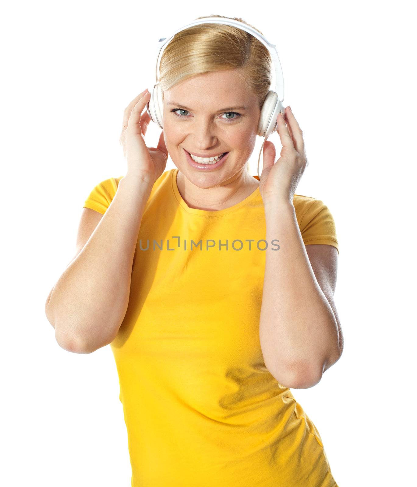 Smiling young lady listening music on her music player