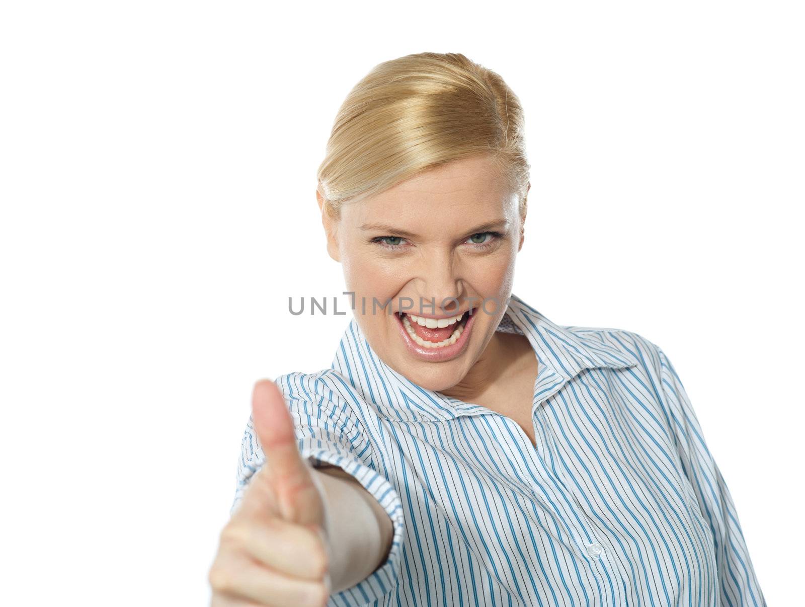 Successful businesswoman showing thumbs-up by stockyimages