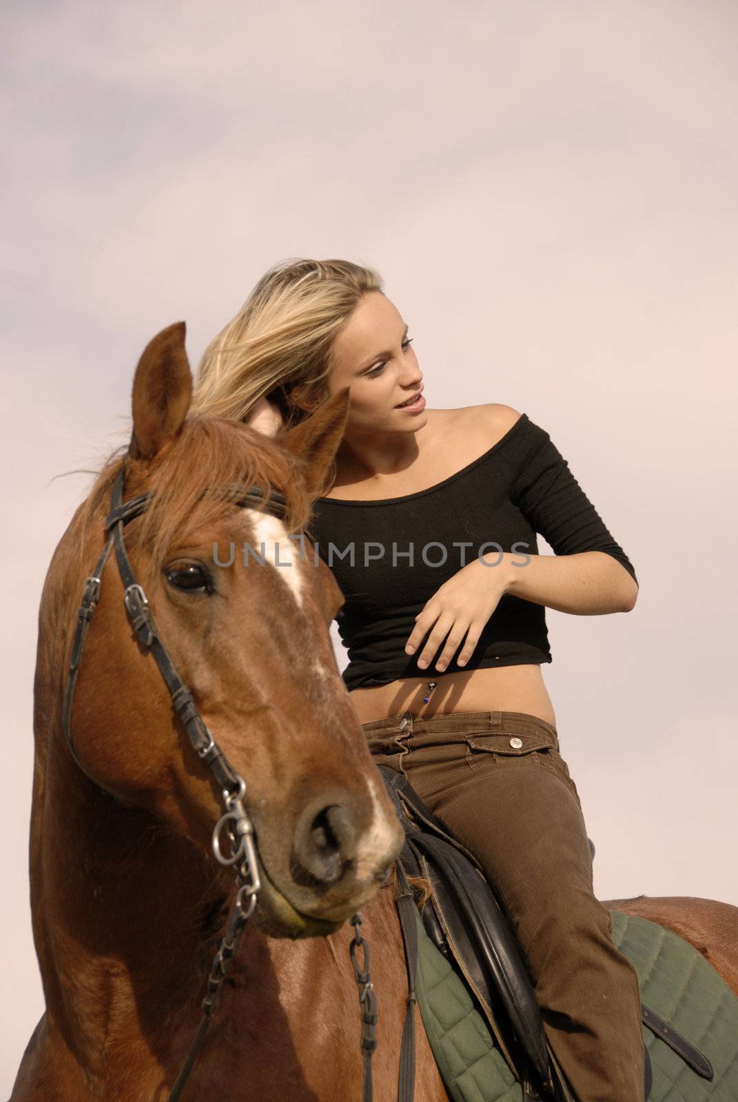 riding girl and her brown stallion. focus on the teen