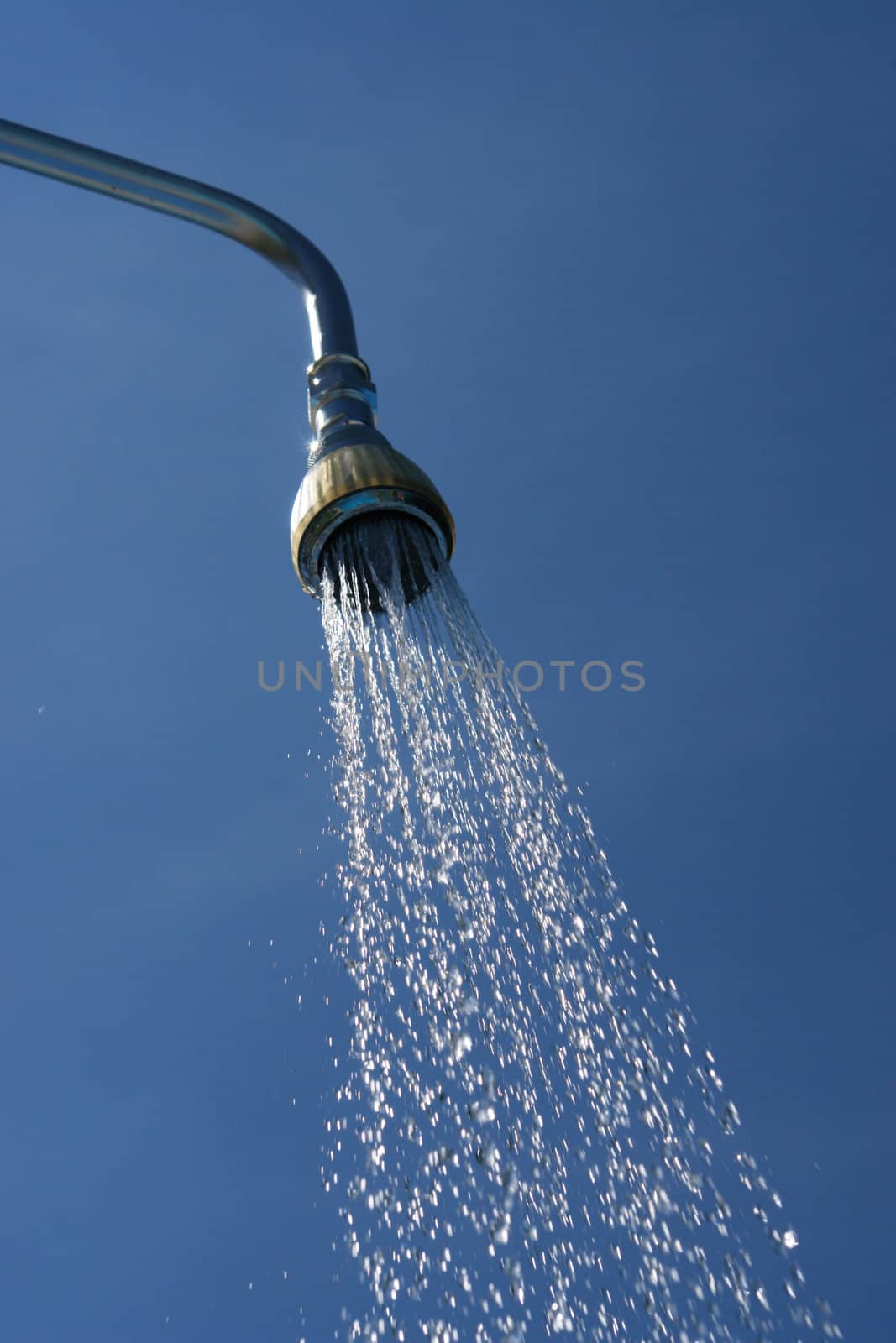 water drops falling from a shower outside