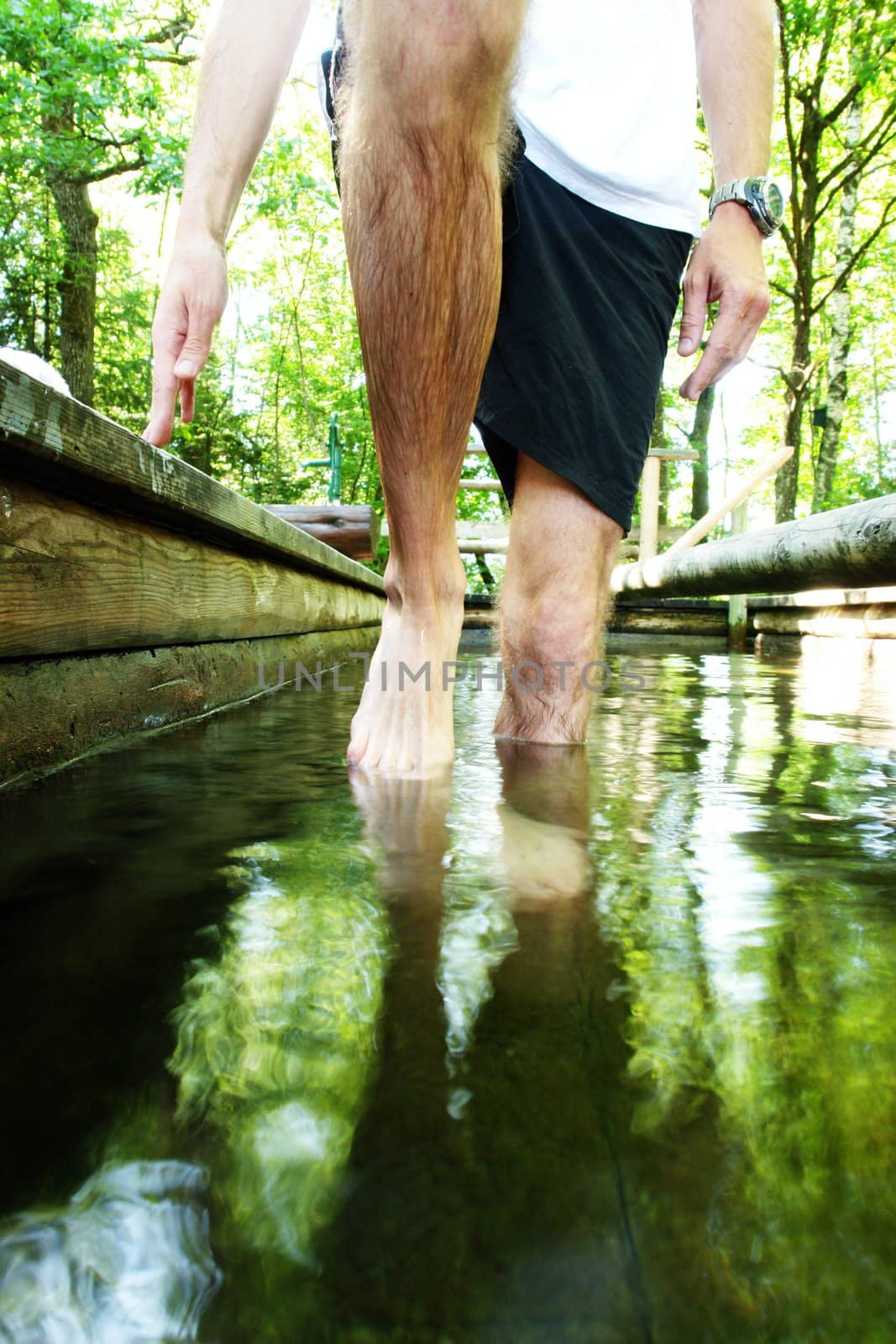 man doing a kneipp water cure outside