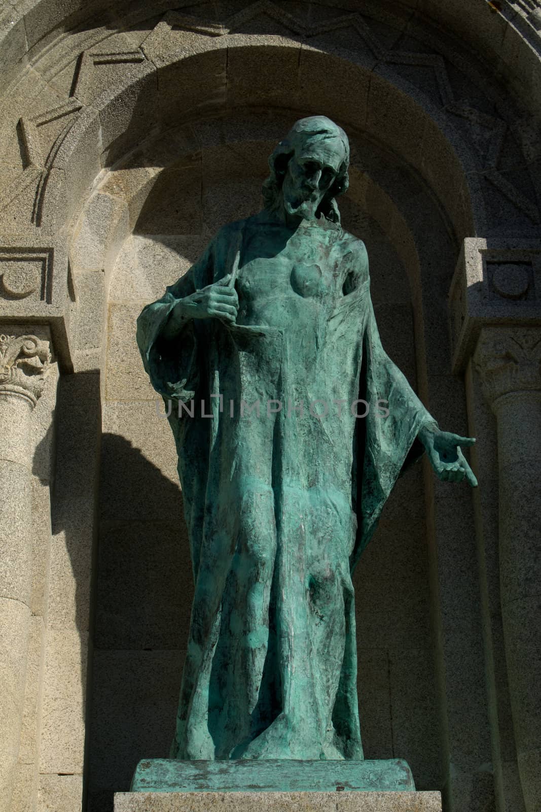 A statue of god in green metal