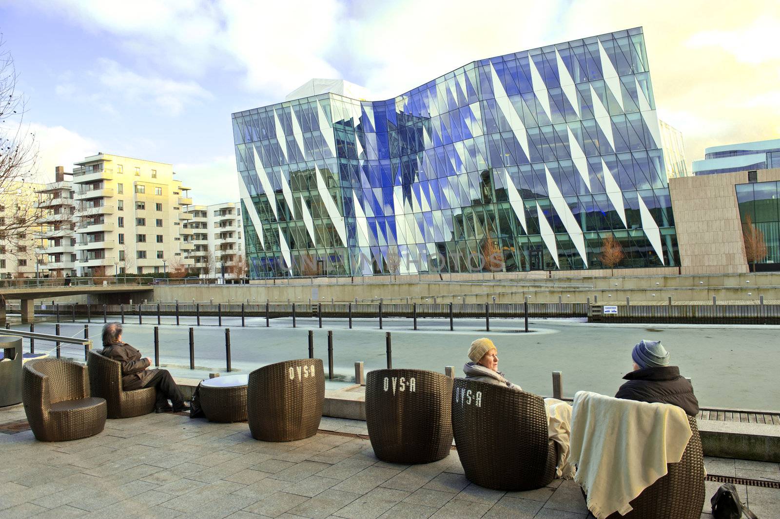 People have a rest on the canal embankment of the modern district of Copenhagen Denmark