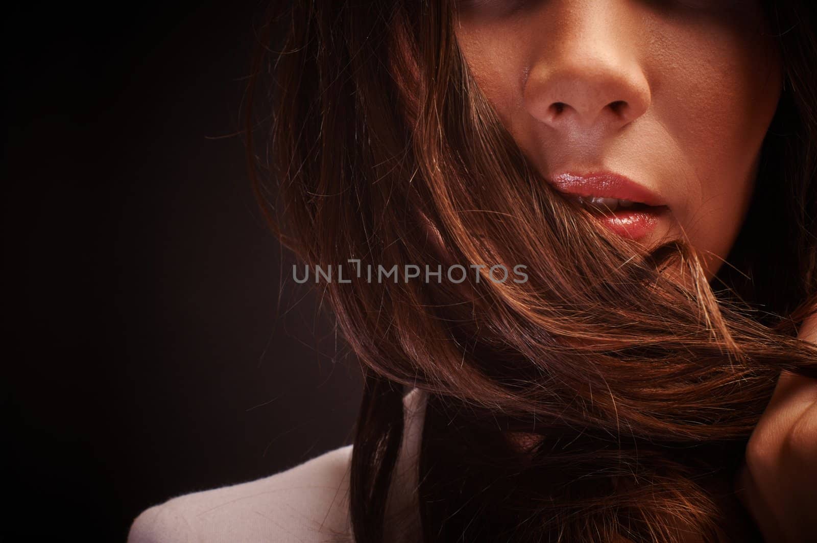 Beautiful young woman against dark background