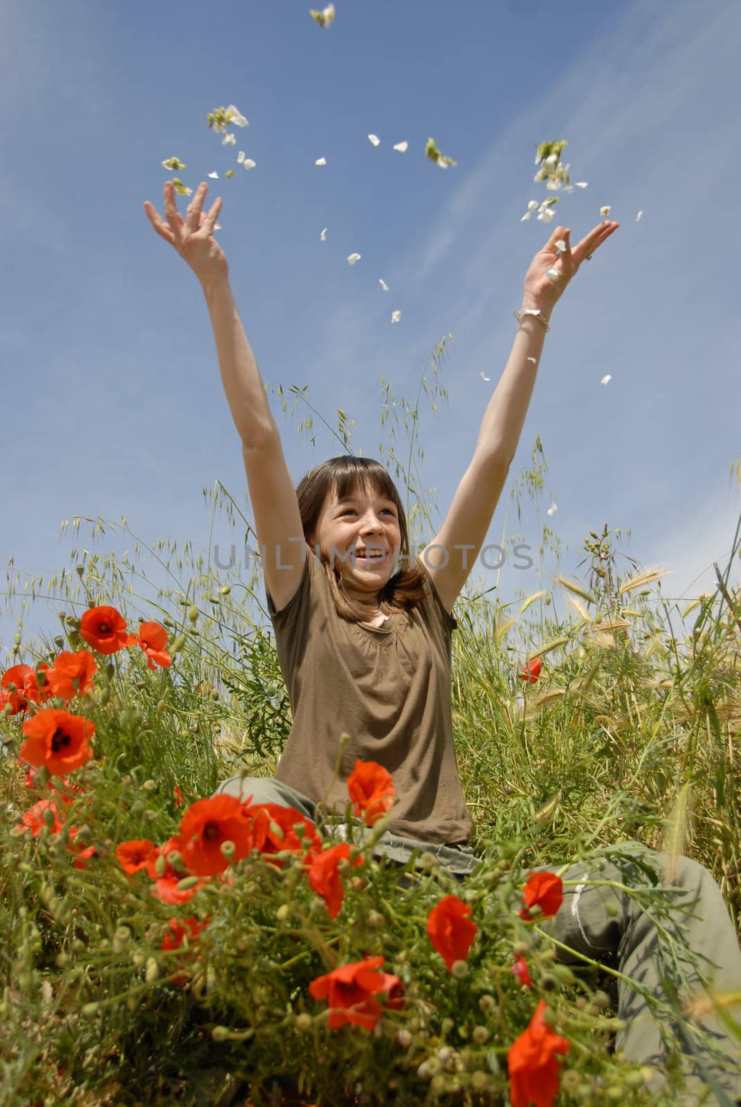 happy young teenager in a field of spring flowers
