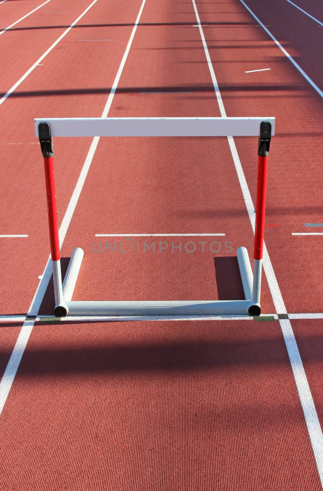 red running tracks with three hurdles set up for training 