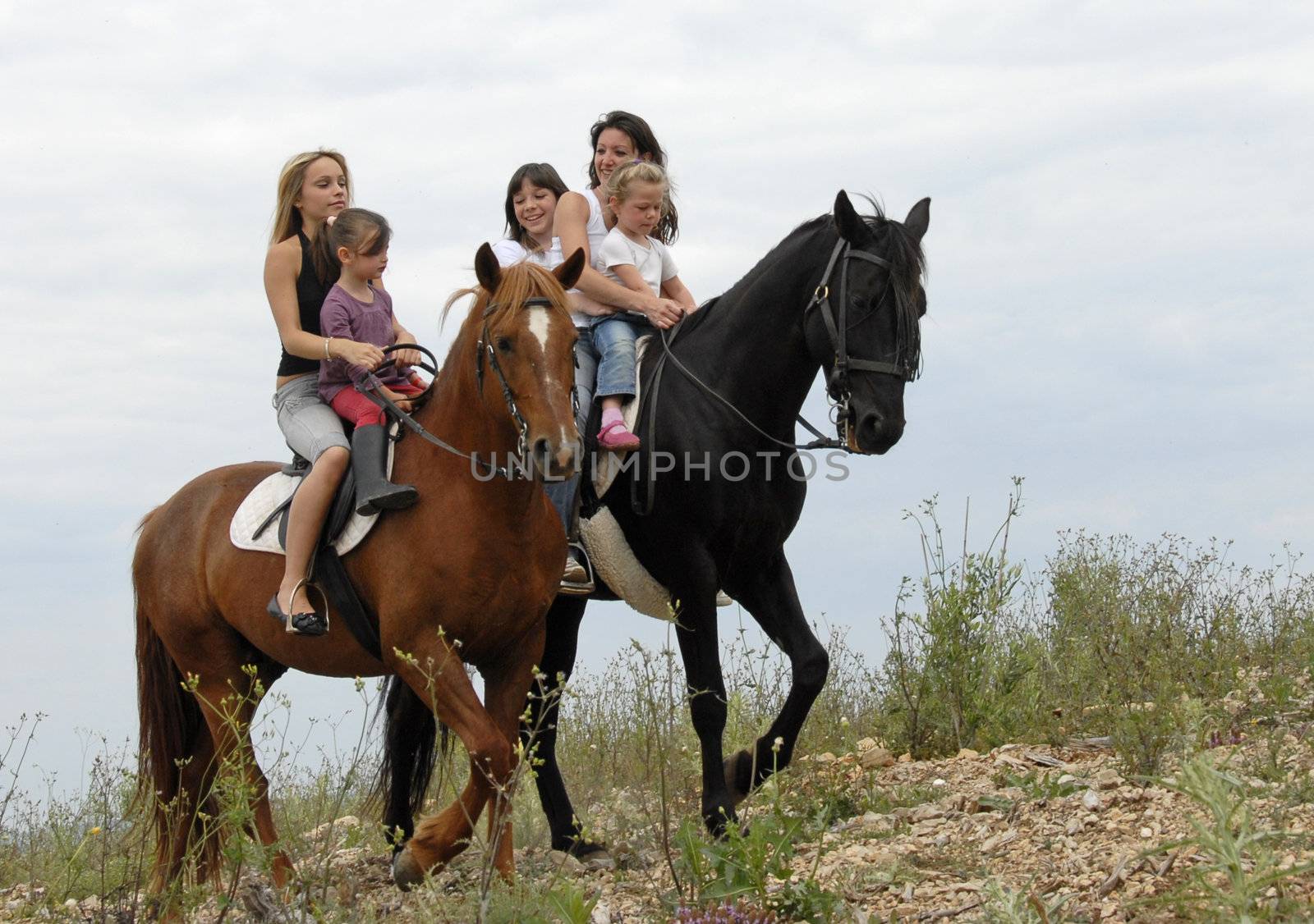 two mother and their children with their horses