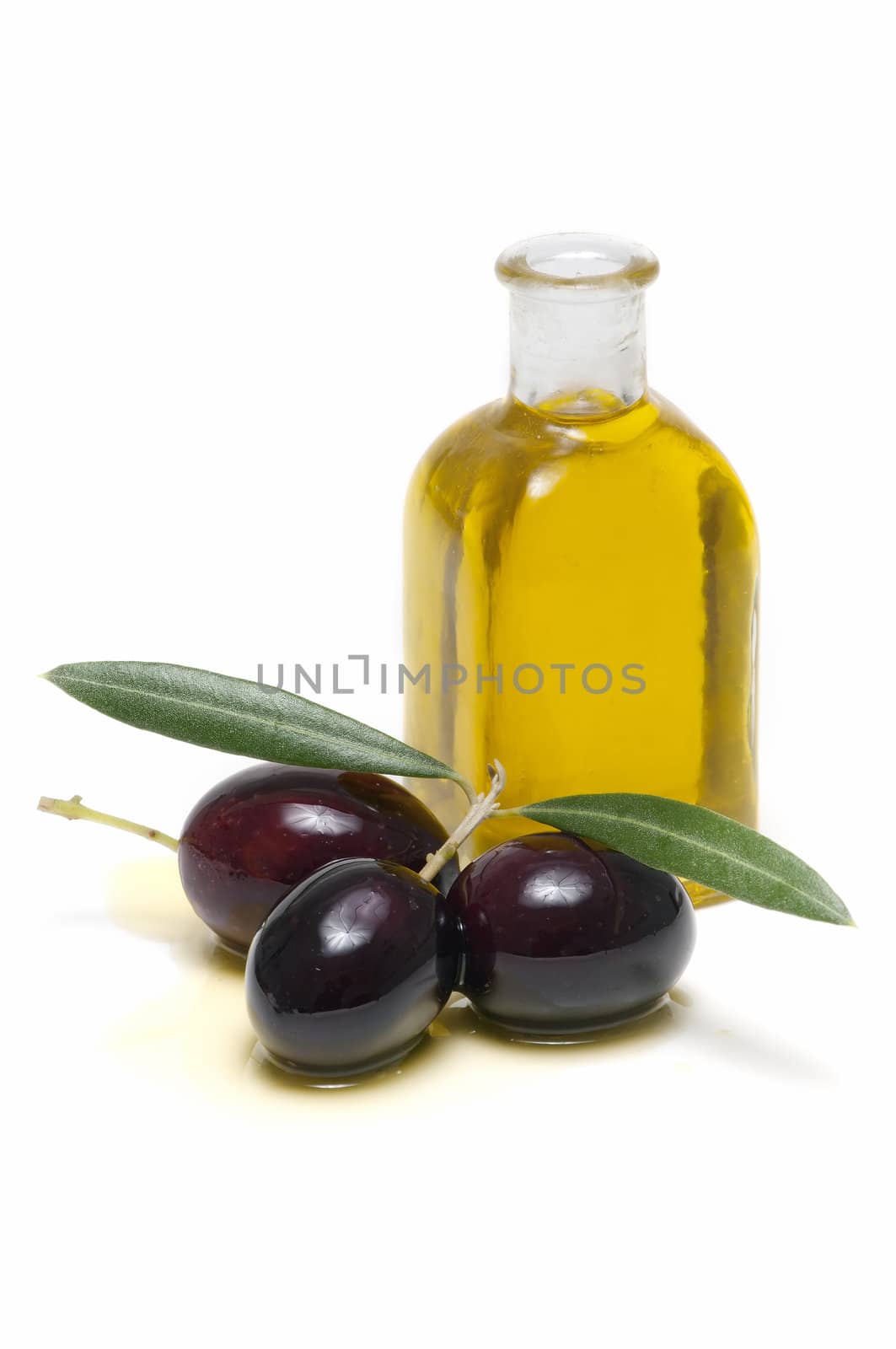 olive oil and fresh olives on white background