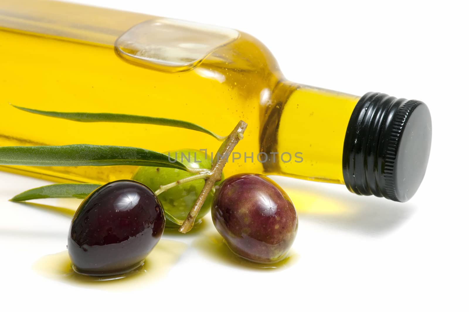 olive oil and fresh olives on white background