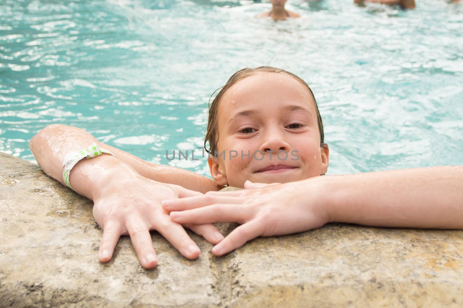 Smiling girl in a swimming pool