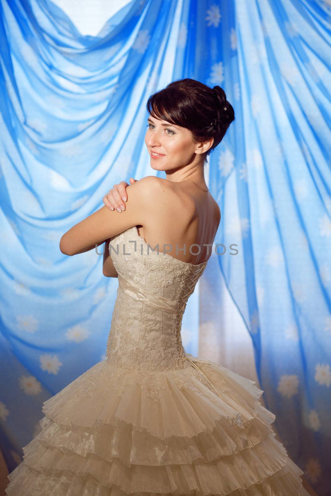 happy bride showing her dress