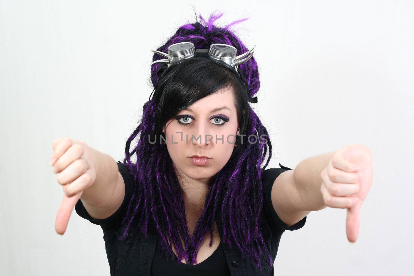 gothic girl with cyberlox and cyber goggle showing the thumb down gesture - isolated on white background